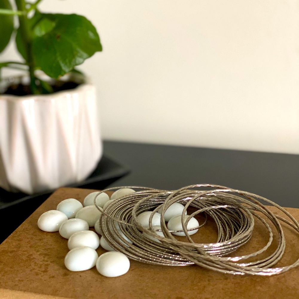 Two sets of silver tone bracelets